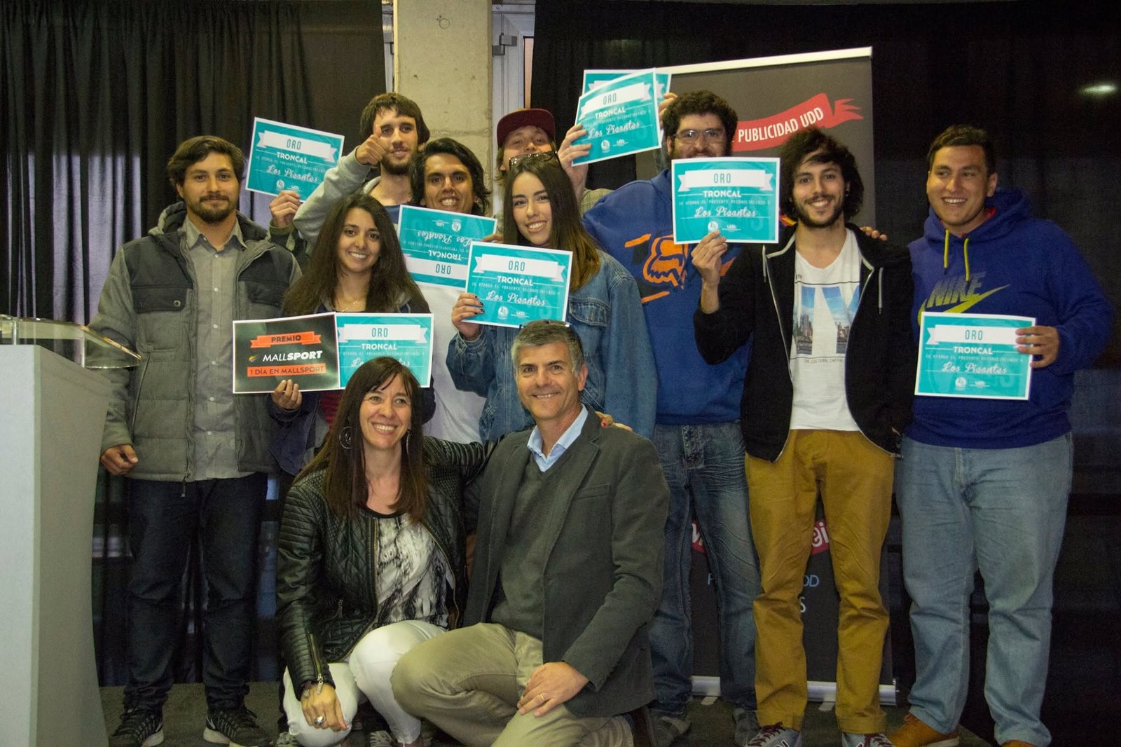 Students and organisers holding awards at the STRESS festival at Universidad del Desarrollo